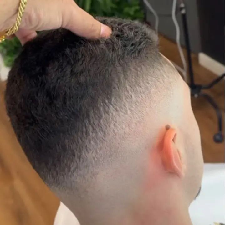 Close-up of a smooth skin fade blend behind the ear