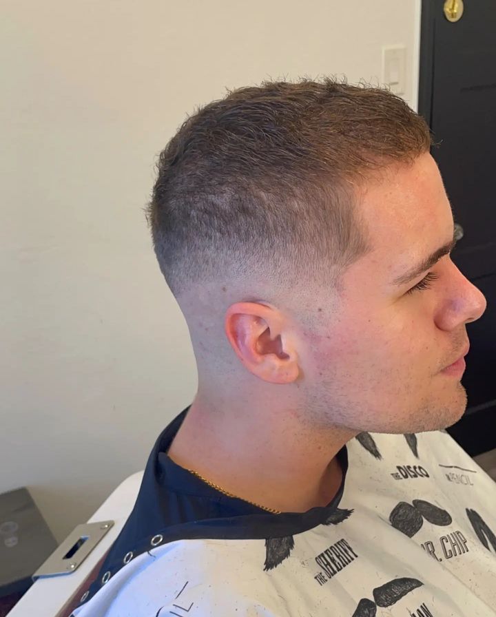 Side profile of a short haircut with a clean taper fade